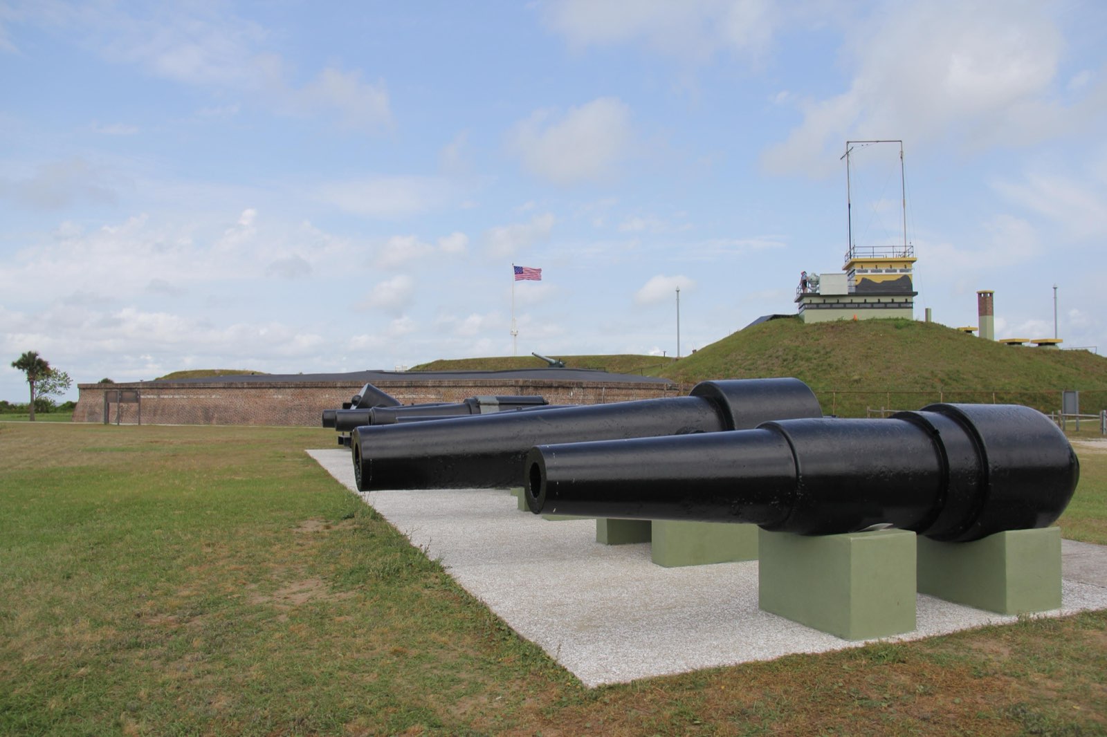 A row of cannon with Fort Moultrie behind; the fort spans 171 years, 1776–1947