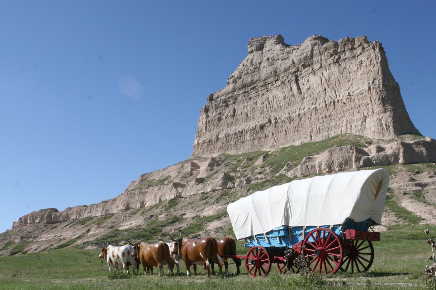 A covered wagon in front of Eagle Rock, which thousands of covered wagons rolled by in the mid-nineteenth century