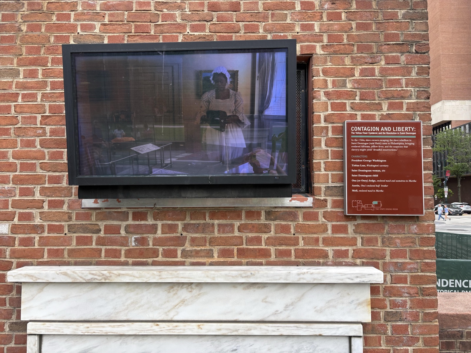 "Contagion and Liberty" (plaque next to a TV monitor) — before