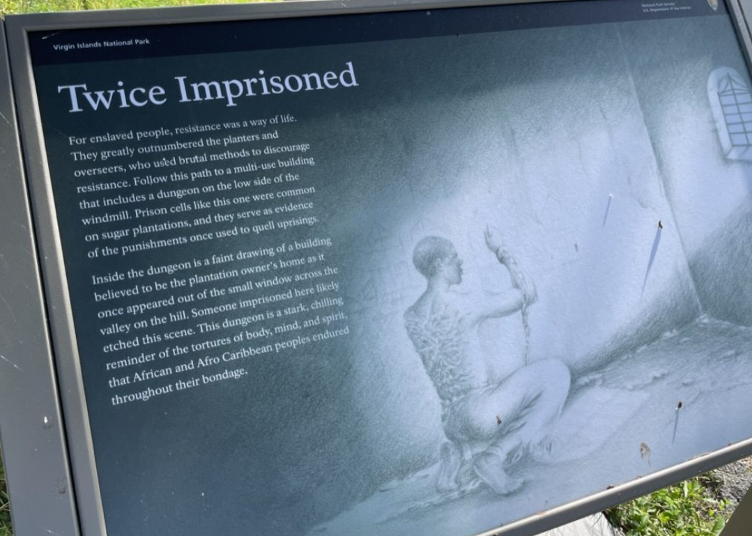 Virgin Islands Twice Imprisoned interpretive sign documenting dungeons used to imprison enslaved people, confirmed removed
